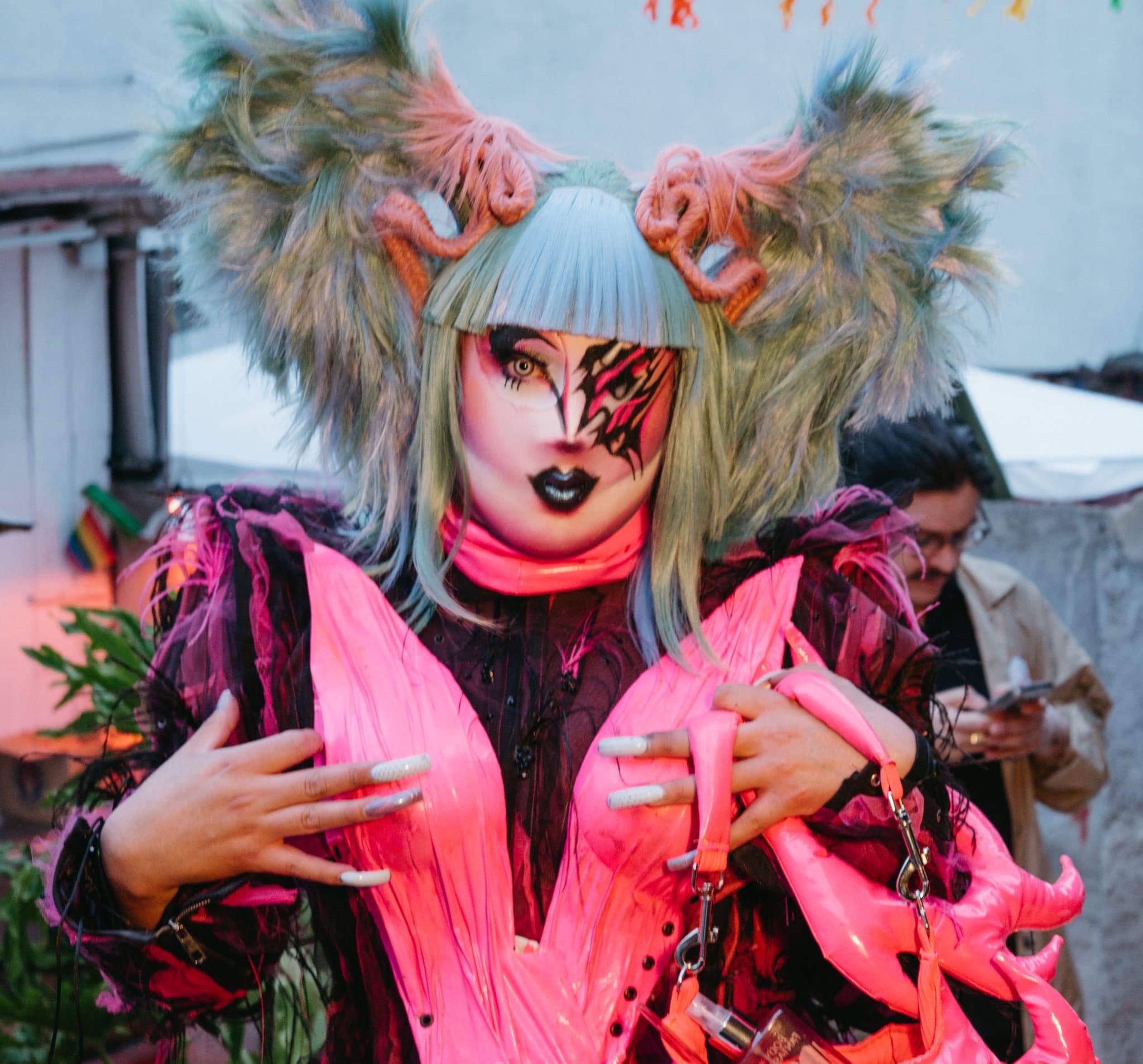 Retrato de artista drag con vestuario rosa y peinado escultórico